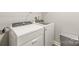 Bright laundry room featuring modern, front load washer and dryer and space-saving storage at 16344 Redstone Mountain Ln, Charlotte, NC 28277
