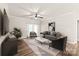 Staged living room showcasing seating, ceiling fan, balcony access, and modern décor at 16344 Redstone Mountain Ln, Charlotte, NC 28277