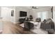 Staged living room featuring contemporary furnishings, TV, ceiling fan and balcony doors at 16344 Redstone Mountain Ln, Charlotte, NC 28277