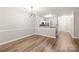 Spacious room featuring sleek floors and a partial view of the kitchen with ample natural light at 16344 Redstone Mountain Ln, Charlotte, NC 28277