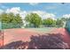 Well-maintained community tennis court surrounded by mature trees and green space at 16344 Redstone Mountain Ln, Charlotte, NC 28277