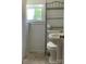 Cozy bathroom with natural light from a window, storage shelves, and neutral tile flooring at 1721 9Th Ne Ave, Hickory, NC 28601