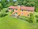 An aerial view showcasing the spacious brick home, a large yard, and a fenced-in patio area at 19924 Floral Ln, Cornelius, NC 28031