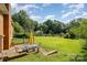 Lovely backyard patio with outdoor dining set, surrounded by a lush green lawn and mature trees at 19924 Floral Ln, Cornelius, NC 28031