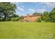 Large backyard with lush lawn and brick home in the background at 19924 Floral Ln, Cornelius, NC 28031