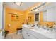 Bathroom with white double vanity and orange walls at 19924 Floral Ln, Cornelius, NC 28031