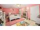 Bright pink bedroom with white furnishings, a soft rug, and whimsical decor for a dream space at 19924 Floral Ln, Cornelius, NC 28031