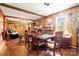 Cozy dining room with wood paneling, brick fireplace, and hardwood floors at 19924 Floral Ln, Cornelius, NC 28031
