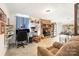Inviting living room with a brick fireplace, a comfortable chair, and an abundance of natural light at 19924 Floral Ln, Cornelius, NC 28031