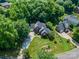 Aerial view of a home nestled among mature trees on a well-manicured lawn at 2043 Shadwell Ct, Gastonia, NC 28056