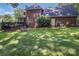 Expansive backyard featuring lush green grass, a deck, and a brick exterior at 2043 Shadwell Ct, Gastonia, NC 28056