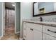 This bathroom features a white vanity with granite top, mirror and walk-in shower at 2043 Shadwell Ct, Gastonia, NC 28056
