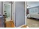 This hallway displays easy access to the bedroom with a ceiling fan and large window at 2043 Shadwell Ct, Gastonia, NC 28056