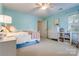 Bedroom with neutral carpet, light teal walls, a ceiling fan, and a window at 2043 Shadwell Ct, Gastonia, NC 28056