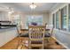 Charming dining area with hardwood floors, plantation shutters, and adjacent kitchen access at 2043 Shadwell Ct, Gastonia, NC 28056