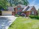 Beautiful brick home with a well-manicured lawn and a spacious driveway at 2043 Shadwell Ct, Gastonia, NC 28056