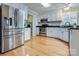 Modern kitchen featuring stainless steel appliances, granite countertops, and white cabinetry at 2043 Shadwell Ct, Gastonia, NC 28056