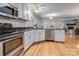 Open kitchen with stainless steel appliances, granite counters, and views into the living room at 2043 Shadwell Ct, Gastonia, NC 28056