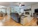 Open-concept living room with hardwood floors, a brick fireplace, and access to the dining area at 2043 Shadwell Ct, Gastonia, NC 28056