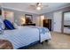 This main bedroom has neutral walls, carpet, and ceiling fan and is brightly lit at 2043 Shadwell Ct, Gastonia, NC 28056