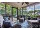 Inviting screened porch with comfortable wicker furniture and beautiful outdoor views at 2043 Shadwell Ct, Gastonia, NC 28056