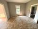 Spacious living room with a window offering natural light and showing unfinished flooring and walls at 235 Jefferson E St, York, SC 29745