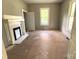The living room features a classic fireplace and bright natural light from two large windows at 235 Jefferson E St, York, SC 29745