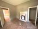 A room showcasing an original fireplace, high ceilings and potential for customization at 235 Jefferson E St, York, SC 29745
