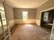 A spacious room with natural light is ready for remodel with original details still intact at 235 Jefferson E St, York, SC 29745