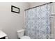 Clean bathroom featuring shower and toilet with blue patterned curtain at 2405 Emma Grace Ln, Rock Hill, SC 29732