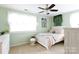 Comfortable bedroom featuring pastel colors, a window, and a ceiling fan at 2405 Emma Grace Ln, Rock Hill, SC 29732