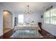 Formal dining room with elegant chandelier, wainscoting, and a view of the outdoors at 2405 Emma Grace Ln, Rock Hill, SC 29732