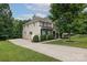 Two-story home with a well-manicured lawn, a large driveway, and mature trees at 2405 Emma Grace Ln, Rock Hill, SC 29732
