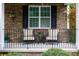 Inviting front porch with stone accents, comfortable seating, and decorative plants at 2405 Emma Grace Ln, Rock Hill, SC 29732