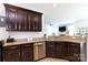 Modern kitchen featuring dark cabinets, stainless steel appliances, and stone countertops at 2405 Emma Grace Ln, Rock Hill, SC 29732
