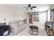 Bright and comfortable living room with a white sofa and display shelves and a view to another room at 2405 Emma Grace Ln, Rock Hill, SC 29732