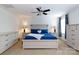 Well-lit main bedroom with light colored furniture, a ceiling fan, and blue accents at 2405 Emma Grace Ln, Rock Hill, SC 29732