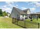 The backyard is fully fenced and includes a pergola with a seating area, offering a private outdoor space at 2606 Cheverny Pl, Concord, NC 28027