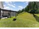 The fenced backyard features a modern pergola with outdoor seating, and plenty of green space at 2606 Cheverny Pl, Concord, NC 28027