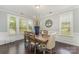 Bright dining room with large windows and a rustic wooden table at 2606 Cheverny Pl, Concord, NC 28027