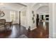 Inviting entryway with hardwood floors leading to the living room and dining area at 2606 Cheverny Pl, Concord, NC 28027