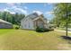 Beautifully landscaped yard with a two-story home featuring stone accents and manicured bushes at 2606 Cheverny Pl, Concord, NC 28027