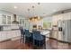Gourmet kitchen boasts granite counters, stainless appliances, white cabinets, and center island with pendant lighting at 2606 Cheverny Pl, Concord, NC 28027