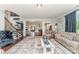 Open-concept living room with hardwood floors and views of the staircase and dining area at 2606 Cheverny Pl, Concord, NC 28027