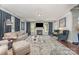 Spacious living room with dark wood floors, a cozy fireplace, and comfortable seating at 2606 Cheverny Pl, Concord, NC 28027