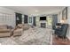 Elegant living room with a fireplace, large area rug, and tasteful decor at 2606 Cheverny Pl, Concord, NC 28027