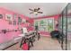 Bright office with pink walls, natural light from the windows, and a ceiling fan overhead at 2606 Cheverny Pl, Concord, NC 28027