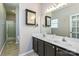 Bathroom featuring double sinks, tile floor, vanity with dark cabinets, and a walk-in shower at 2614 Ocracoke St, Charlotte, NC 28208