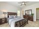 Bedroom with ceiling fan, dresser, and queen size bed at 2614 Ocracoke St, Charlotte, NC 28208