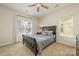 Bedroom featuring a queen bed, ceiling fan, and two windows at 2614 Ocracoke St, Charlotte, NC 28208
